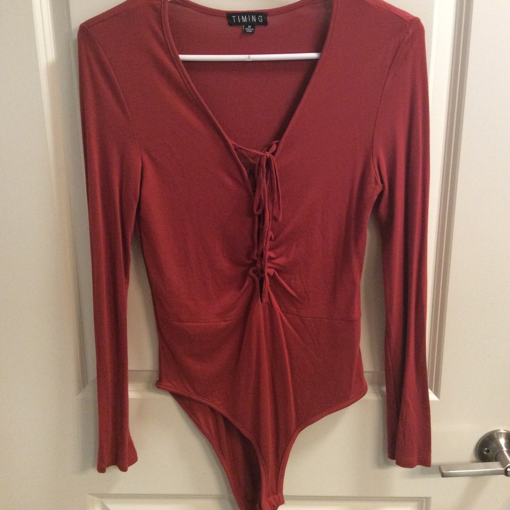 Burnt red body suit